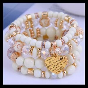 New bracelet with 4 strands with cream-colored stones and very beautiful gold-